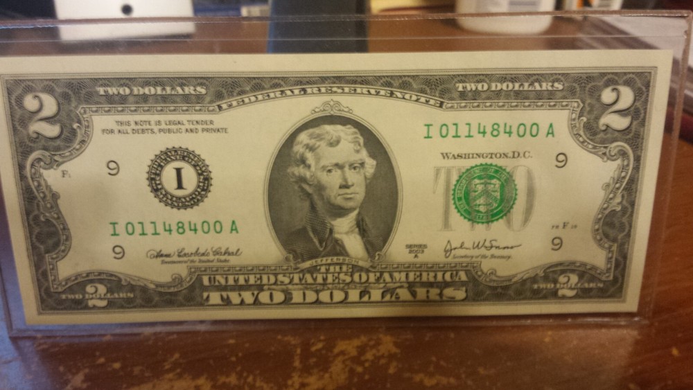 2003A ONE–TWO DOLLAR BILL UNCIRCULATED IN HOLDER.