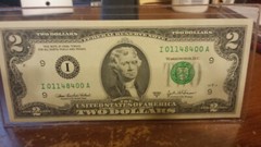 2003A ONE–TWO DOLLAR BILL UNCIRCULATED IN HOLDER.